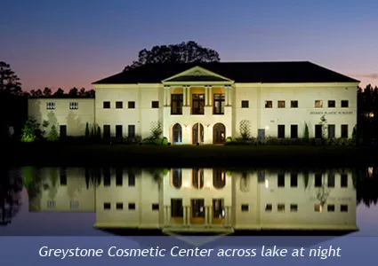 Greystone Cosmetic Center across lake at night